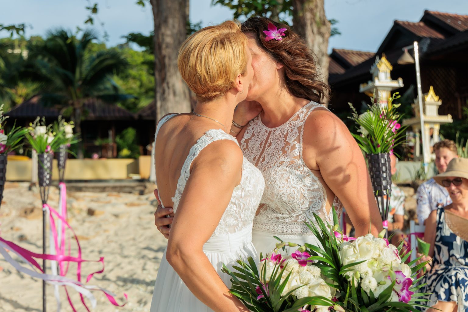 two brides kissing