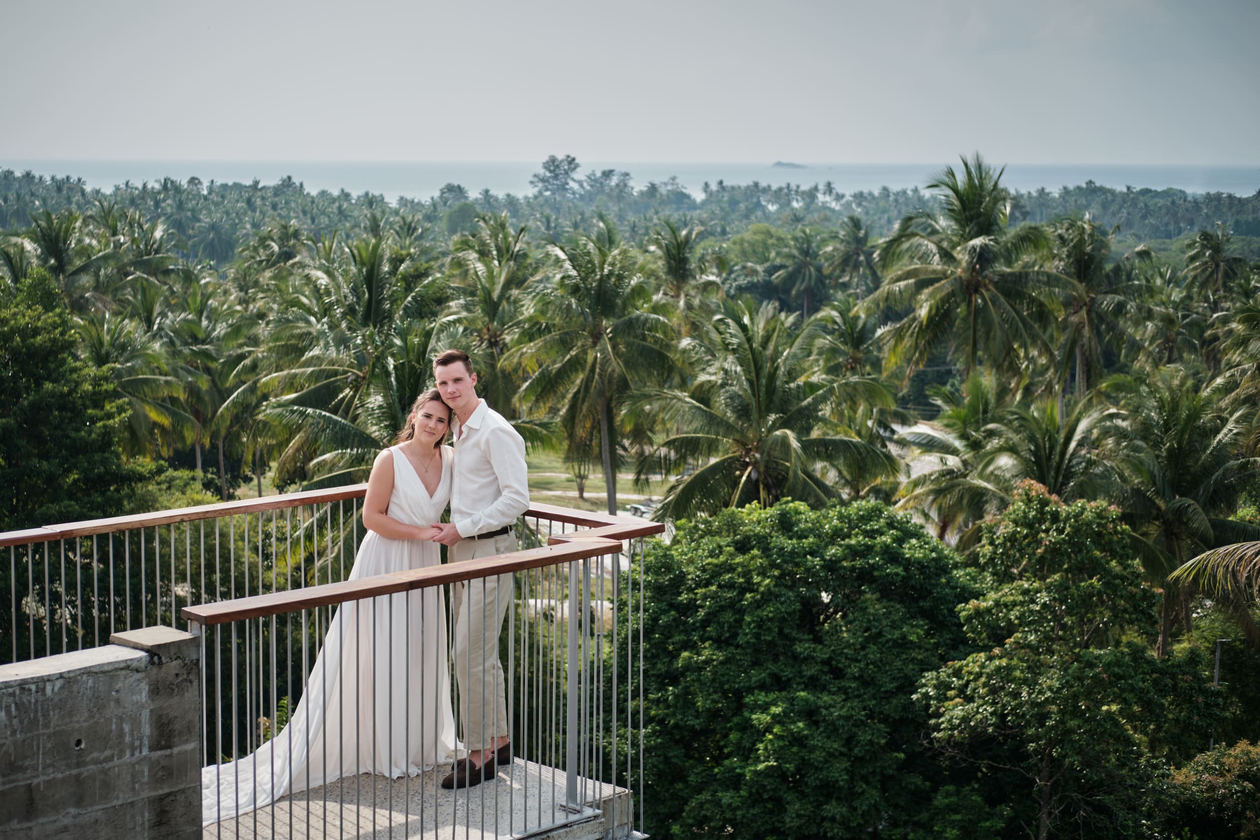 wedding couple shooting palm trees
