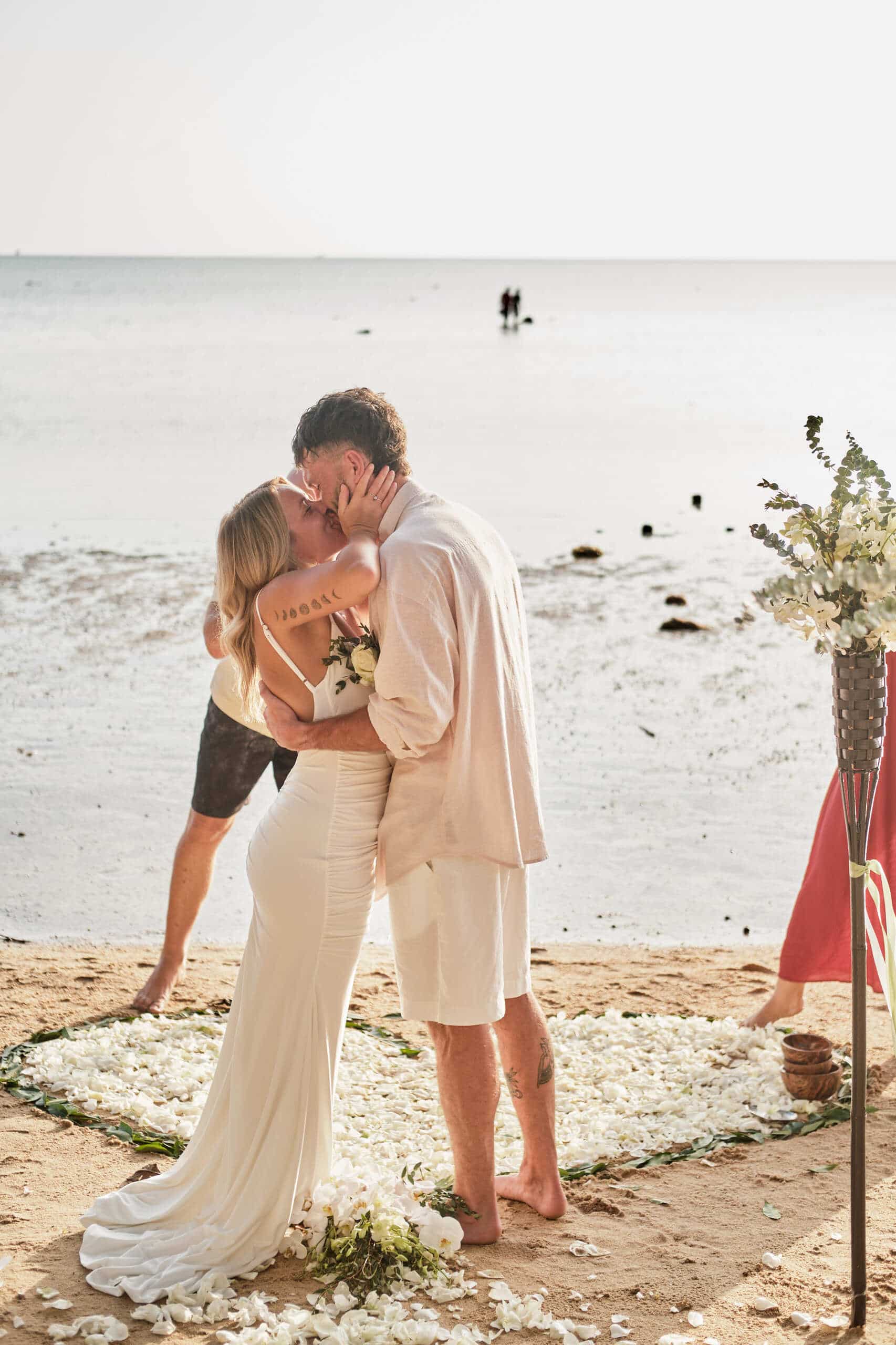 beach wedding couple kiss