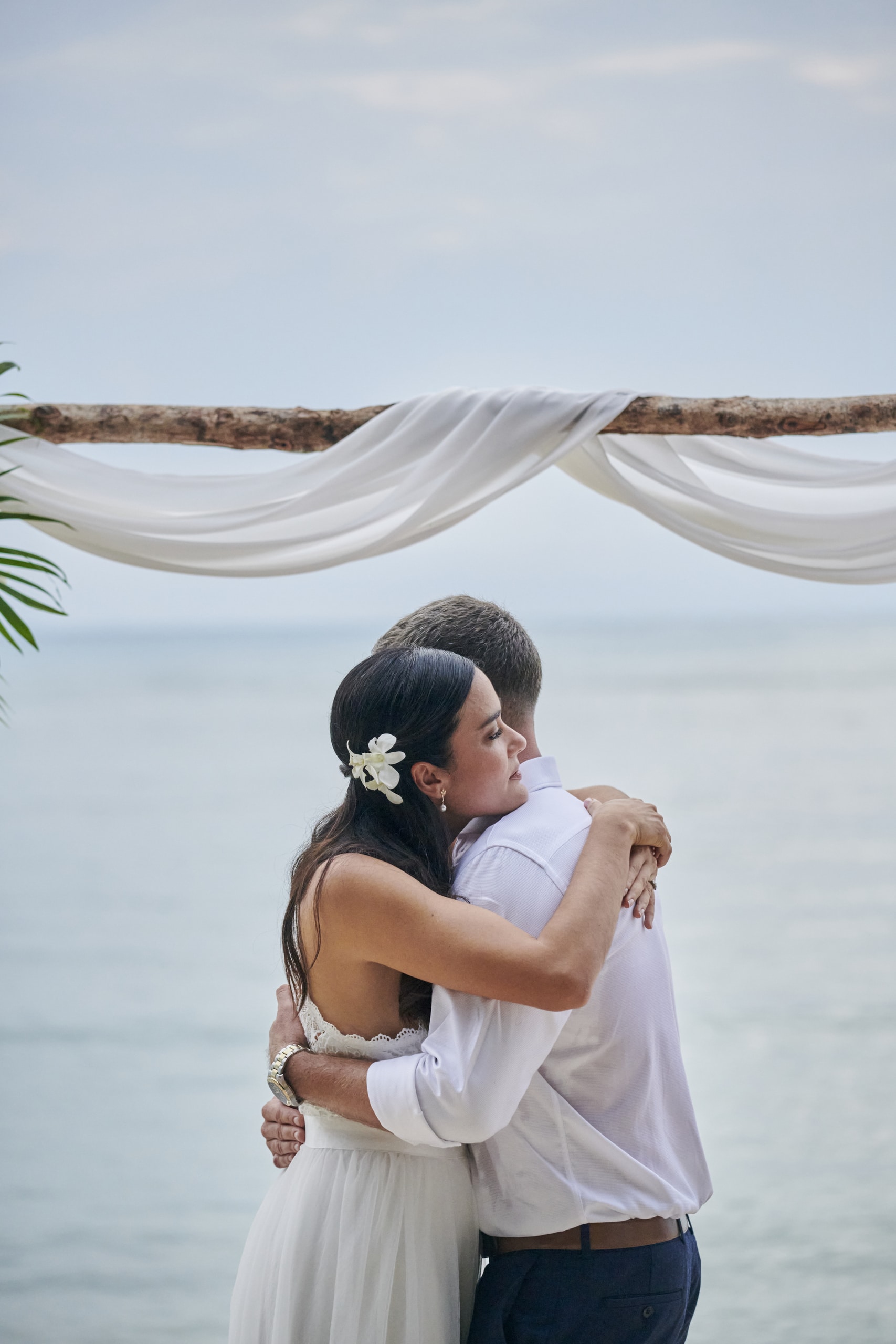 beach wedding couple hug