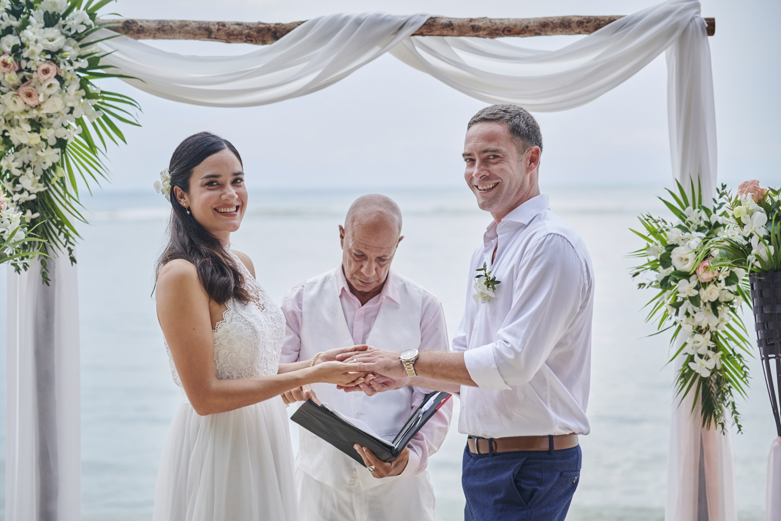 beach wedding couple holding hands