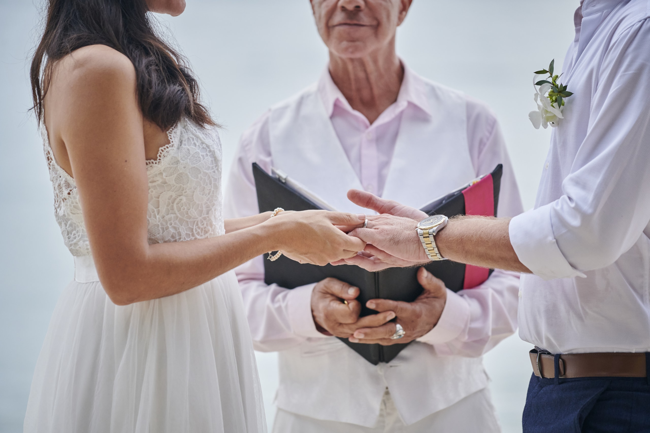 beach wedding couple holding hands