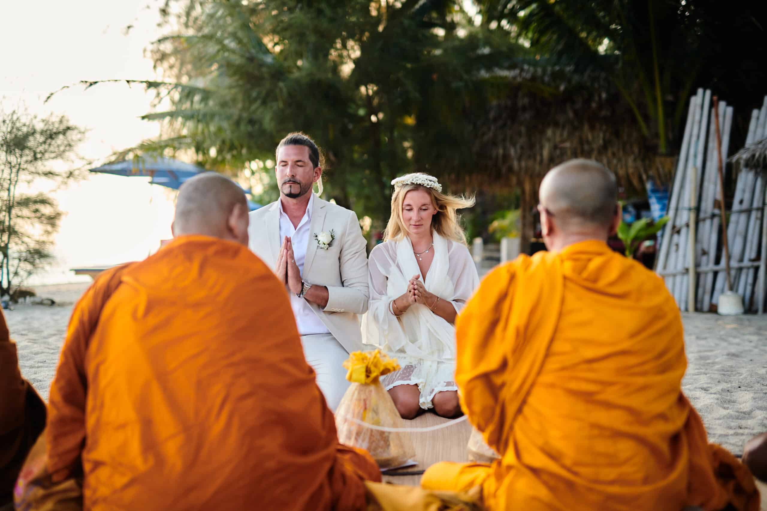 beach wedding monk blessing couple