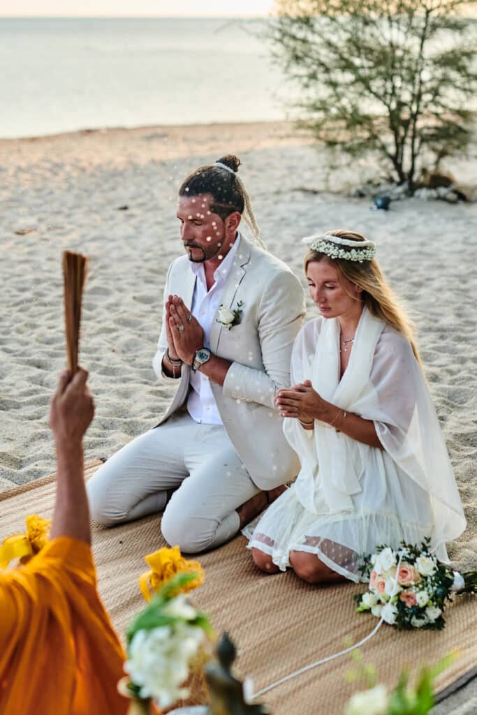 beach wedding monk blessing couple