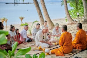 beach wedding monk blessing bride and groom