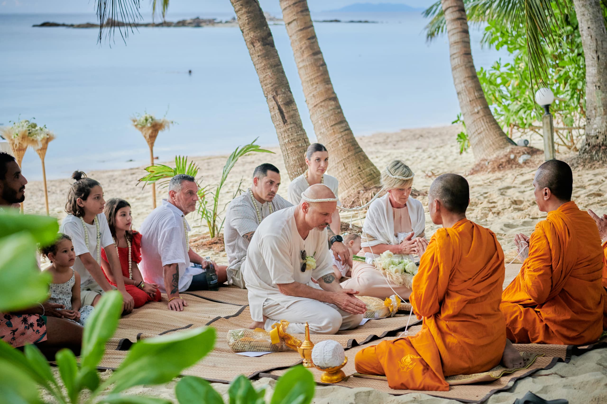 beach wedding monk blessing bride and groom