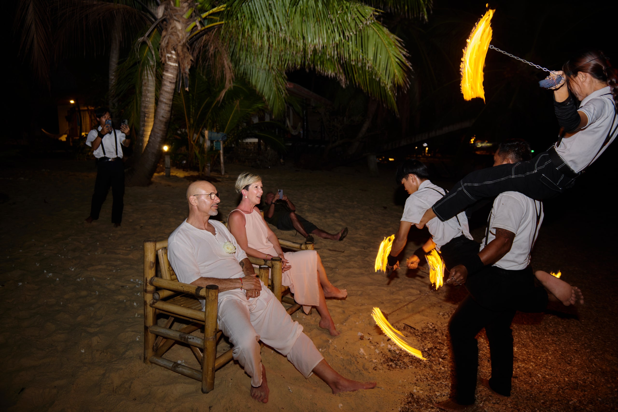 beach wedding fire show at night