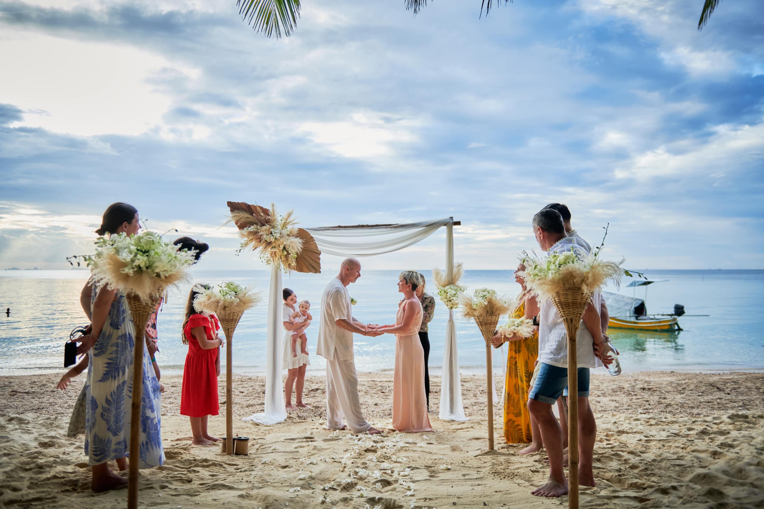 beach wedding ceremony couple and guests